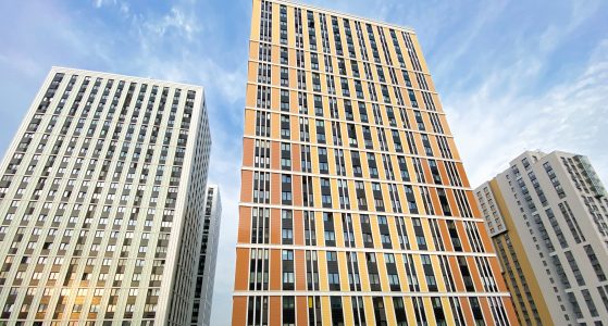 New multi-storey apartment block houses. Tall as skyscrapers. Blue sky. Copy space